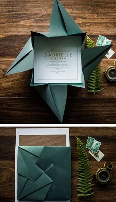 an origami star is folded in green paper and sits on top of a wooden table