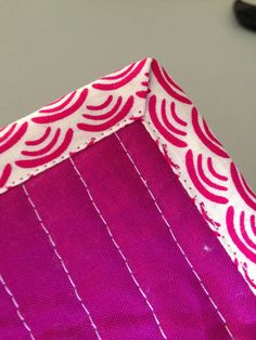 a close up of a pink and white box