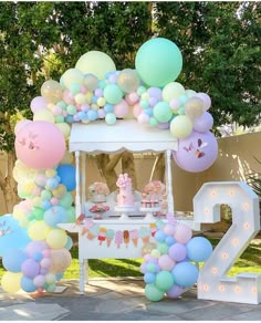 an outdoor birthday party with balloons and decorations