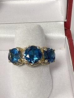 This is a very pretty ring we made years ago. The ring was recently traded in and we put the 3 new blue topaz in it. The ring weighs 6.8 grams and makes a nice bold impressions, and is in very good shape Pretty Ring, Pretty Rings, 14k Gold Ring, 3 Things, Halo Diamond, The 3, Blue Topaz, Gold Ring, Topaz