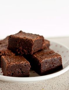 several pieces of brownie on a white plate