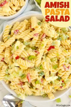 two bowls filled with pasta salad and the words amish pasta salad on top of it