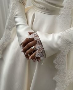 the hands of two people dressed in white