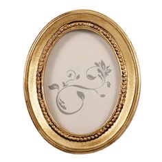 an oval gold frame with floral designs on it