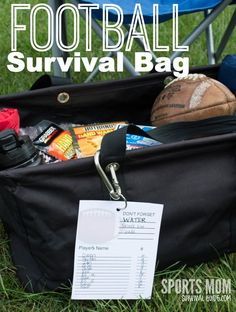 a football survival bag sitting on top of a grass covered field with sports equipment in it