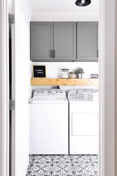 a white washer and dryer sitting inside of a kitchen next to a doorway