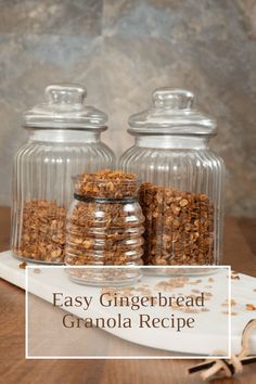 two glass jars filled with granola on top of a wooden table