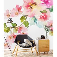 a floral wallpaper with pink flowers on it and a black chair in front of the wall