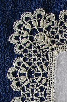 two pieces of white crocheted doily with leaves on the edge and one piece of lace