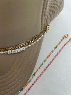 Hat chains - accessorizing your hats. "Navy" everyday go to layer gold curb chain. 3mm width attached lobster clasp on each end measuring 9". Listing is for one gold hat chain ATTENTION: ALL SALES FINAL NO RETURNS OR REFUNDS. Removable Double Lobster Clasp Tarnish Resistant Chain Emily Colvard x BD "In my mom era" hat can be purchase on Stitchin' Pretty's website. stitchinpretty.com Trucker Hat Chain Diy, Trucker Hat Chains, Custom Hat Ideas, Hat Chain, Pearl Hat, Customized Clothes, Hat Charms, Pretty Website, In My Mom Era