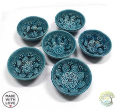 six blue bowls with designs on them