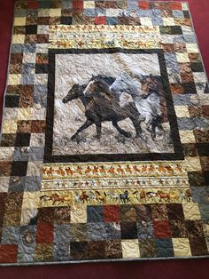 a quilt with two horses running in the same direction on top of each other,