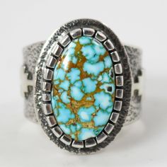 Sterling Silver Ring with Appliqué Designs and set with Natural Kingman Turquoise from Arizona. Ring Size: 11.625” Setting Width, .875” Setting Height.5” Band Width Artisan Turquoise Ring Jewelry, Southwestern Style Turquoise Ring, Western Style Turquoise Ring Collectible, Southwestern Turquoise Open Ring, Turquoise Cabochon Ring Jewelry, Western Style Gemstone Ring, Southwestern Style Turquoise Open Ring, Western Style Gemstone Ring Jewelry, Collectible Turquoise Jewelry With Large Stone