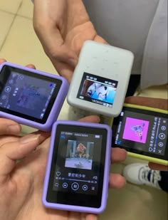 three people holding up their cell phones in the shape of small devices with pictures on them