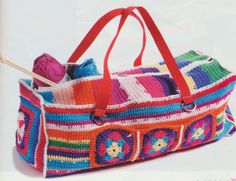 a multicolored crocheted bag with yarn and knitting needles in the handles