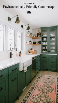 a kitchen with green cabinets and white counter tops, an area rug on the floor