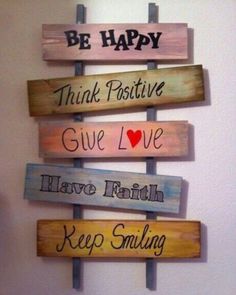 a wooden sign that says be happy, think positive, give love and have faith keep smiling