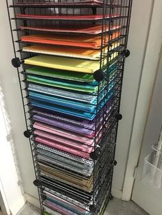 a rack that has many different colored fabrics on it and is next to a door