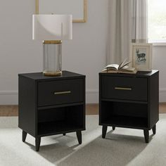 two black nightstands with one open book on top and the other closed in front