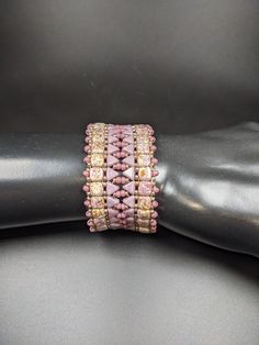 Stunning Tile Bracelet in muted marbled gold and soft pinks. This Tile bracelet is an absolute pleasure to wear. Made of glass Tiles and Kheops beads, it is flexible and substantial. The stunning soft color palette goes with most any clothing choice from casual to dressy. Magnetic clasps are the most easy clasps to fasten and unfasten one handed, and this fold over clasp takes that one step farther by providing a secure fastening that wont open until you take it off. The bracelet is 8 inches in Tile Bracelet, Fairy Ears, Glass Tiles, Delicate Details, Green Crystals, Glass Tile, Gold Stars, Fold Over, Soft Colors