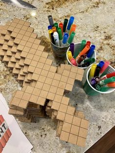 a table topped with lots of crafting supplies on top of a wooden cutting board