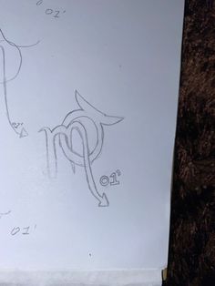 a white piece of paper with some drawings on it's side and numbers drawn on it