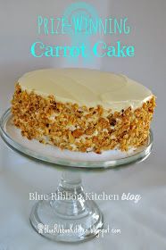 a cake with white frosting sitting on top of a glass plate