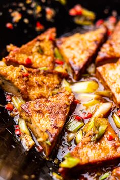 some food is being cooked in a pan on the stove top and ready to be eaten