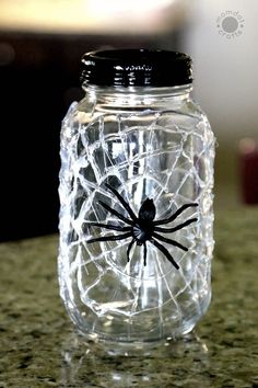 a glass jar with a spider on it