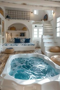 an indoor jacuzzi tub in the middle of a room with stairs leading up to it