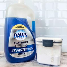 a gallon of dawn next to a canister of detergent on a marble counter