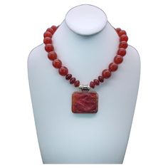 One-of-a-Kind Richly colored 18m.m. Carnelian gemstone necklace. The red Carnelian pendant suspended from the necklace is a 2”x11/2 Carnelian Dragon richly carved into the stone. The dragon symbol of the emperor in China is particularly powerful when it is in red the symbol also symbolizes good fortune. The clasp is a carnelian cabochon set in sterling silver. Silk hand-knotted Approx: 18 inch . Elegant Carnelian Necklaces With Natural Stones, Elegant Carnelian Necklace With Natural Stones, Elegant Orange Agate Necklace, Formal Amber Jewelry With Gemstone Beads, Elegant Carnelian Necklace With Large Pendant, Carnelian Single Strand Jewelry For Gifts, Formal Necklace With Natural Stones And Agate, Formal Agate Necklace With Natural Stones, Formal Orange Carnelian Necklace