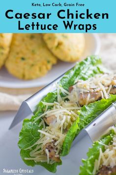 two lettuce wraps with cheese on them and some crackers in the background