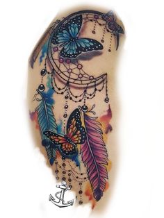 a colorful tattoo with butterflies and feathers on it