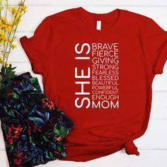 "Make Mom's day extra special with our She is Mom Mother's Day Bible Verses t-shirt. This perfect gift for the best mom in your life is crafted from high-quality materials for a luxurious and comfortable feel. With a variety of vibrant colors and captivating designs to choose from, you can find the perfect t-shirt to match your personality and style. 👕 Elevate your wardrobe with our premium personalized t-shirts crafted from high-quality materials for an exquisite feel against your skin. Choose Mothers Day Tshirt Ideas Design, Inspirational Crew Neck T-shirt As Gift, Red Name Print T-shirt For Gift, Red T-shirt With Name Print For Gift, Mother's Day Red Graphic Tee, Red Mother's Day Graphic Tee, Red Letter Print T-shirt For Gift, Red Letter Print T-shirt As Gift, Red T-shirt With Letter Print As Gift