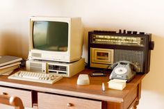 an old fashioned computer sitting on top of a wooden desk