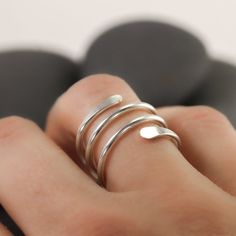 This simple coiled ring wraps around your finger like a snake or a spring. It is mostly smooth, except for the hammered ends, which overlap on the front for the perfect kind of statement ring. It's available in recycled sterling silver, gold or rose gold fill. I will gladly make the ring as either a knuckle ring or as a traditional ring for regular wear at the base of the finger.Made from recycled sterling silver or gold fill. The photographed ring is 3 wraps, for reference.If you need more time Adjustable Spiral Snake Ring As Gift, Adjustable Spiral Midi Rings In Minimalist Style, Ring Wraps, Traditional Ring, Spiral Ring, Knuckle Ring, Knuckle Rings, A Snake, Wrap Rings