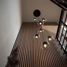 an overhead view of a room with wooden flooring and chandelier hanging from the ceiling