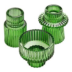 three green glass vases sitting next to each other