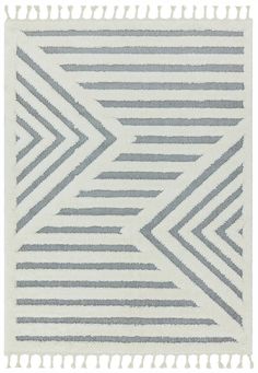 a gray and white rug with tassels on the bottom, in diagonal stripes