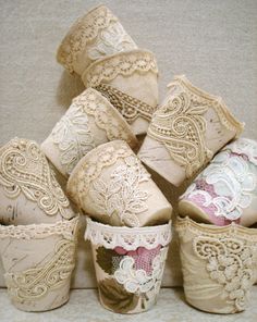 there are many lace covered cups on the shelf