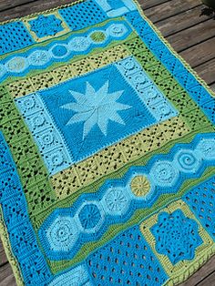 a crocheted blanket on a wooden deck