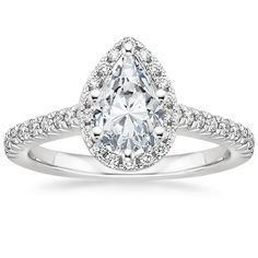 an oval cut diamond ring with pave set shoulders