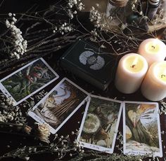 candles and tarot cards on a table