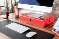 an apple computer sitting on top of a wooden desk