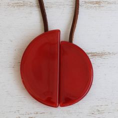 a red object is hanging on a brown cord