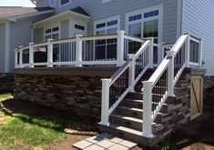 a house with stone steps leading up to the front door and stairs on each side