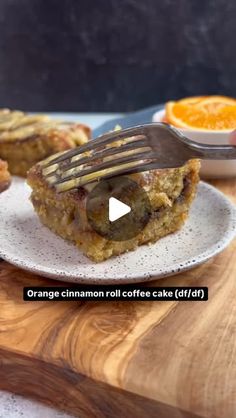 an orange cinnamon roll coffee cake is on a white plate with a fork in it