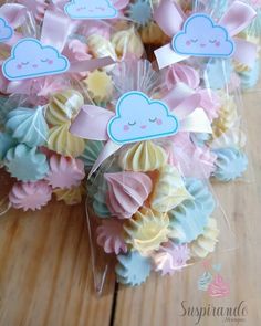 some cupcakes are wrapped in clear cellophane and have clouds on them