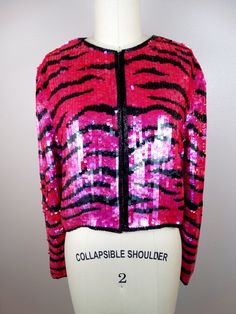 "This is a breathtaking piece of glam! It's all hand embellished with neon pink sequins in a wild striped tiger design and accented with black glass beading along the edges. It's in perfect condition! Bust - 40\" Shoulders - 16\" Sleeves - 23\" Top to Bottom - 17\" Tag Size - Large All of my items come from a smoke-free and pet-free home. If you have any questions, please don't hesitate to ask!" Glamorous Fitted Pink Outerwear, Vintage Sequin Fitted Outerwear, Pink Embellished Fitted Outerwear, Vintage Fitted Sequin Outerwear, Fitted Pink Embellished Outerwear, Fitted Vintage Outerwear For Party, Wild Tiger, Tiger Design, Sequin Jacket